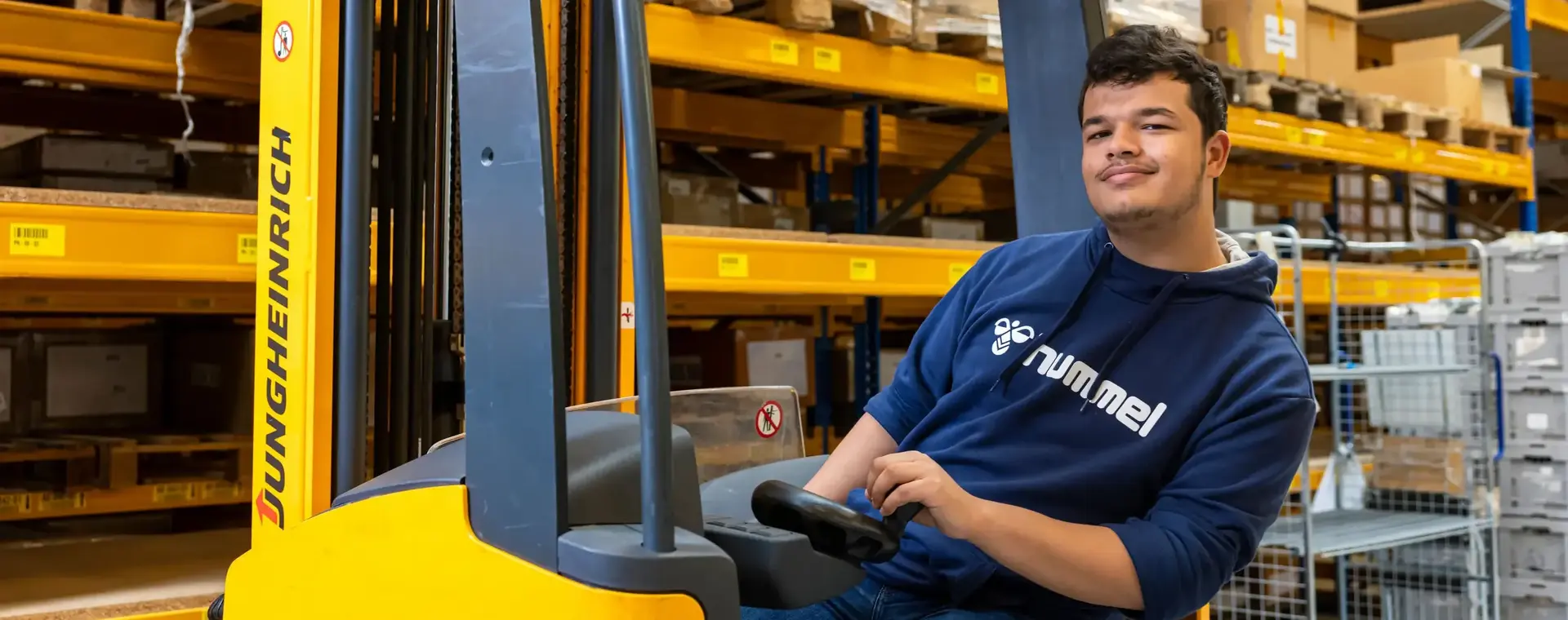 Student logistiek zit op een heftruck in een magazijn