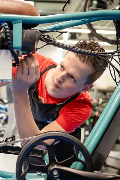 Student in werkplaats sleutelt aan fatbike