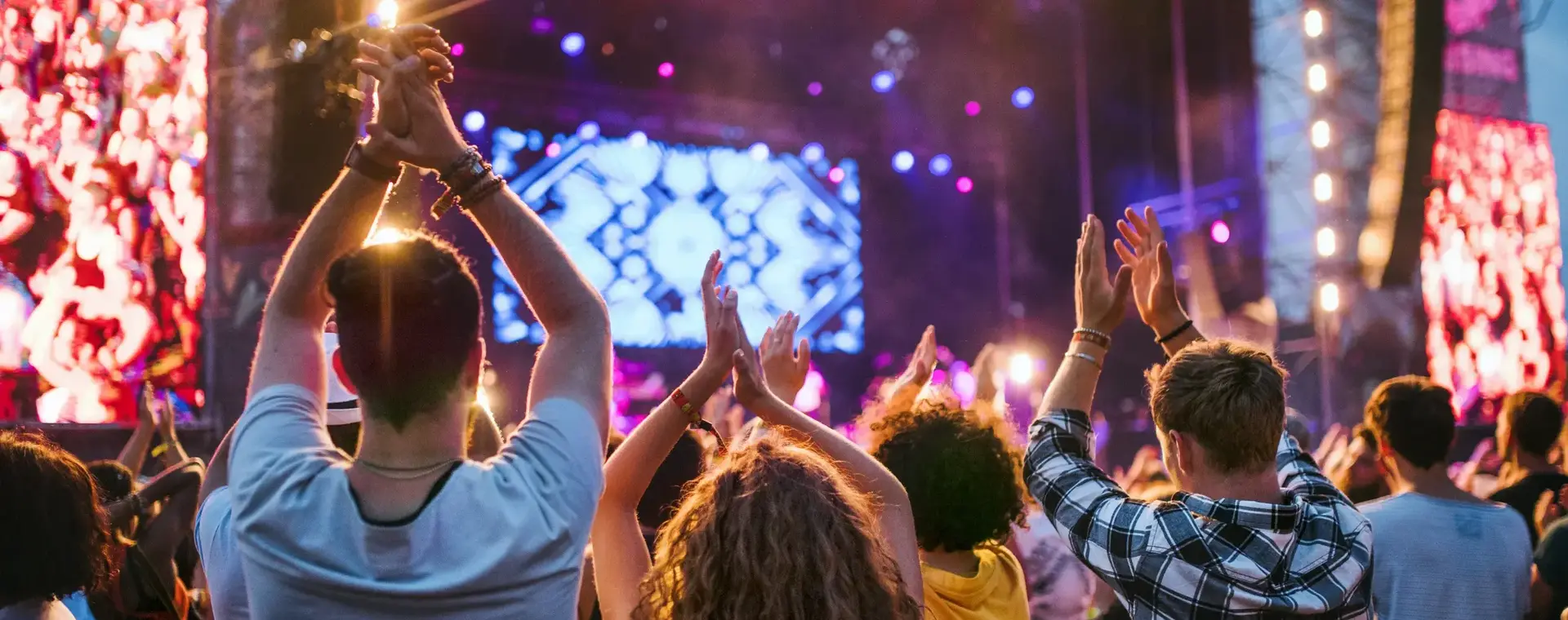 Een grote groep klappende mensen voor een podium bij een groot event