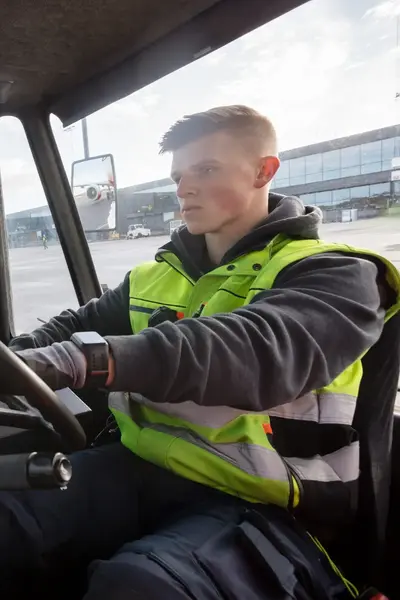 Student in vrachtwagen op luchthaven.