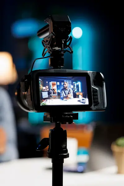 Cameramonitor met vaag op de achtergrond een student.